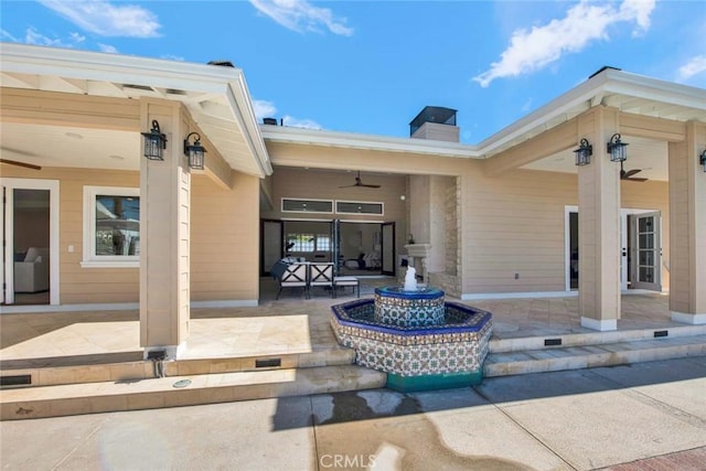 exterior space with ceiling fan and a patio