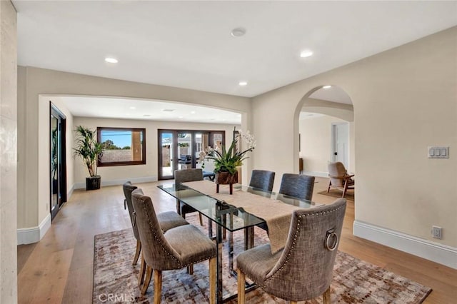 dining room featuring french doors and light hardwood / wood-style floors