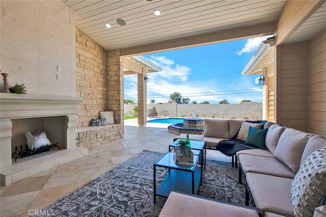 view of patio / terrace featuring an outdoor living space with a fireplace and a fenced in pool