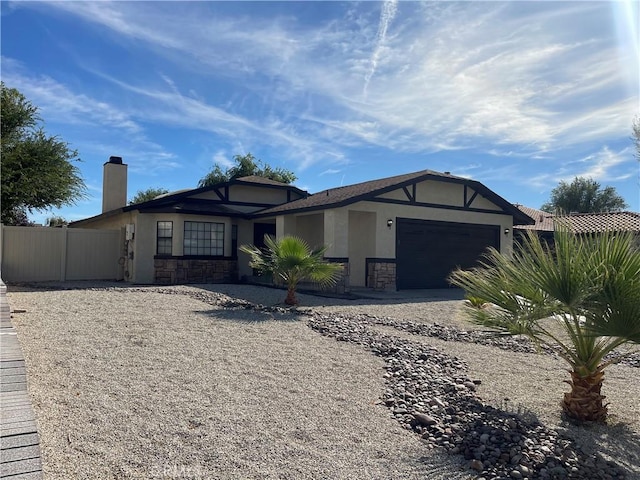 13165 Caspian Dr, Victorville, CA 92395 - single story home featuring a chimney, stone siding, fence, a garage, and stucco siding