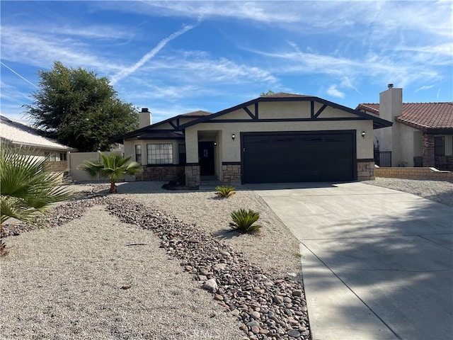 13165 Caspian Dr, Victorville, CA 92395 - ranch-style home with driveway, stone siding, a chimney, a garage, and stucco siding