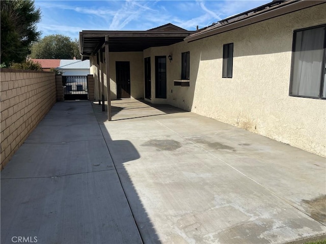 13165 Caspian Dr, Victorville, CA 92395 - view of patio with a gate, fence, and a carport