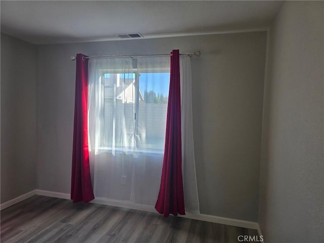 13165 Caspian Dr, Victorville, CA 92395 - empty room featuring baseboards, wood finished floors, and visible vents