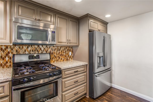 kitchen with light stone countertops, stainless steel appliances, dark hardwood / wood-style floors, and tasteful backsplash