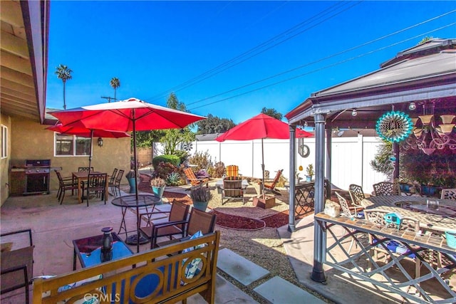 view of patio / terrace with an outdoor fire pit and a grill