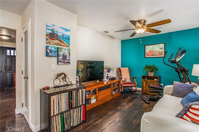 living room with ceiling fan and dark hardwood / wood-style flooring