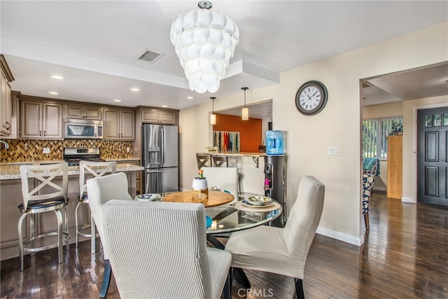 dining area with sink and dark hardwood / wood-style flooring