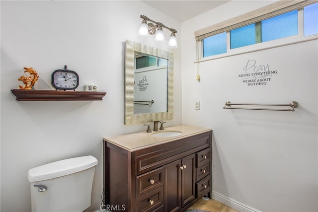 bathroom featuring vanity, toilet, and tile patterned flooring