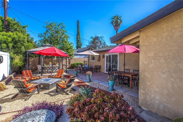 view of patio / terrace with an outdoor fire pit