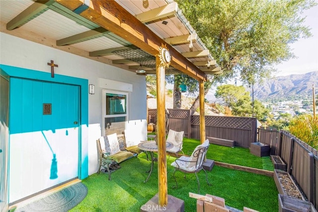 view of yard with a fenced backyard and a mountain view