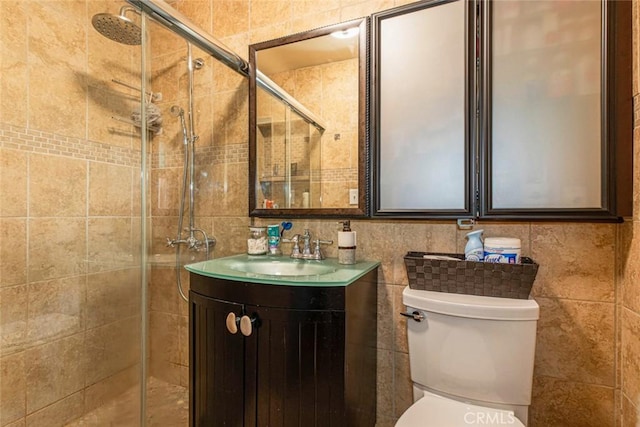 full bathroom featuring tile walls, tasteful backsplash, toilet, a stall shower, and vanity