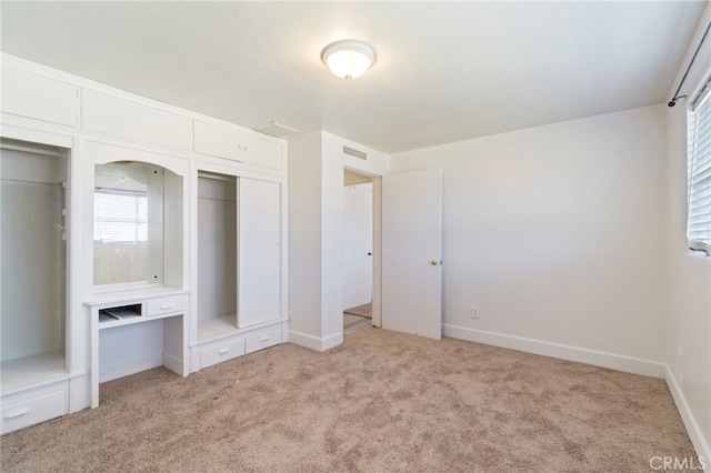 unfurnished bedroom featuring light colored carpet