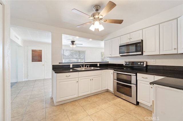 kitchen featuring sink, light tile patterned flooring, white cabinetry, appliances with stainless steel finishes, and ceiling fan