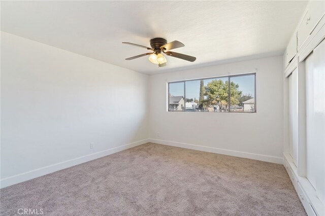 carpeted empty room with ceiling fan