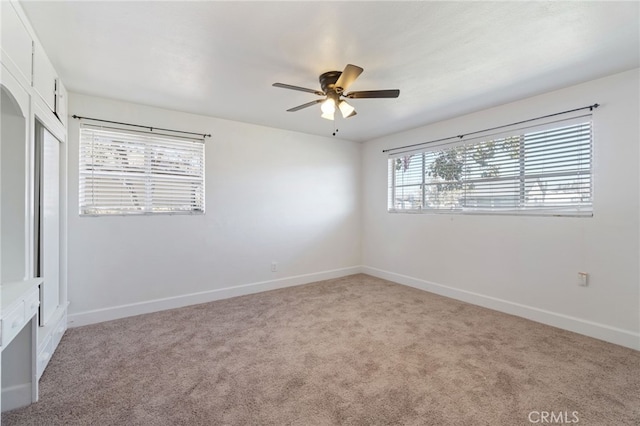 carpeted empty room with ceiling fan