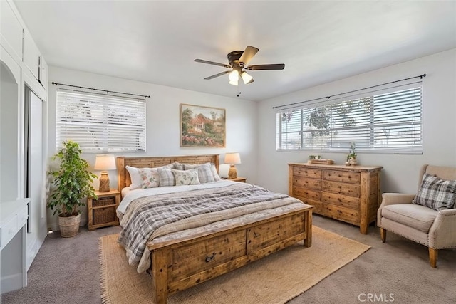 bedroom featuring light carpet and ceiling fan