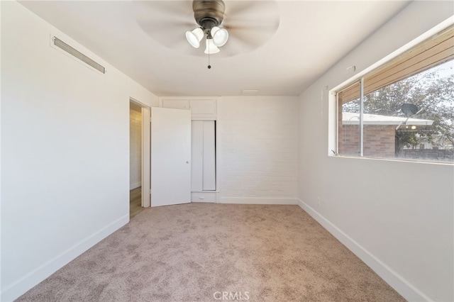 spare room with light carpet and ceiling fan