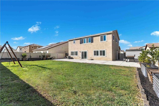 back of house featuring a patio, a yard, and central AC unit