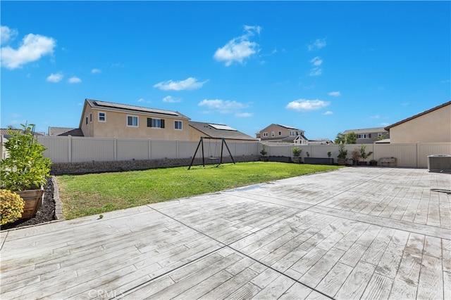 wooden deck featuring central air condition unit, a patio area, and a lawn