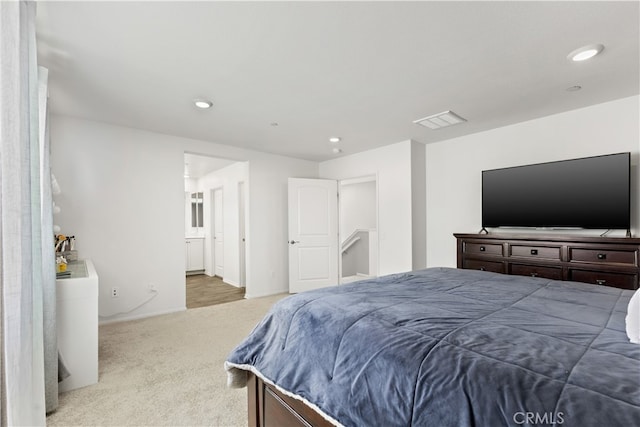 bedroom with carpet floors and connected bathroom