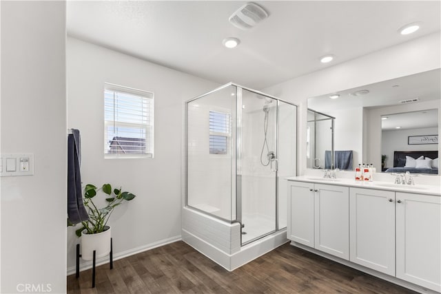 bathroom featuring vanity, hardwood / wood-style floors, and an enclosed shower