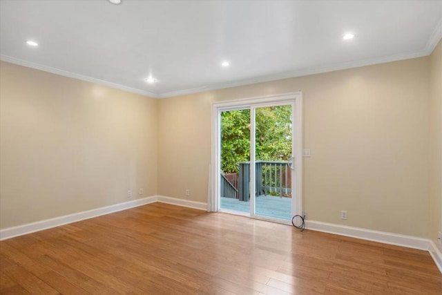 unfurnished room featuring light hardwood / wood-style floors and crown molding