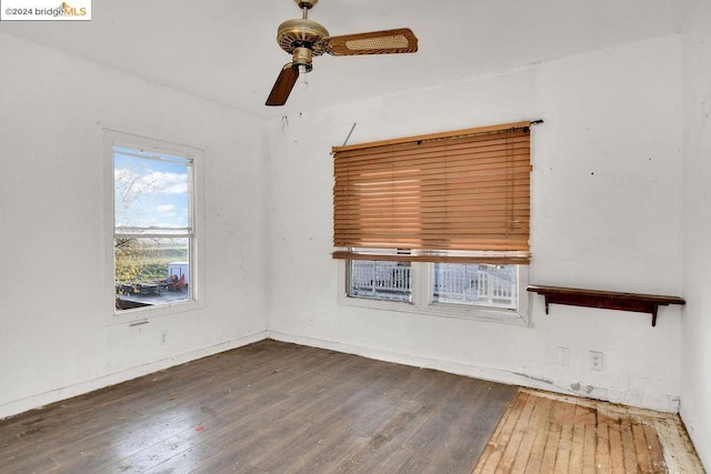 unfurnished room featuring ceiling fan and dark wood-type flooring