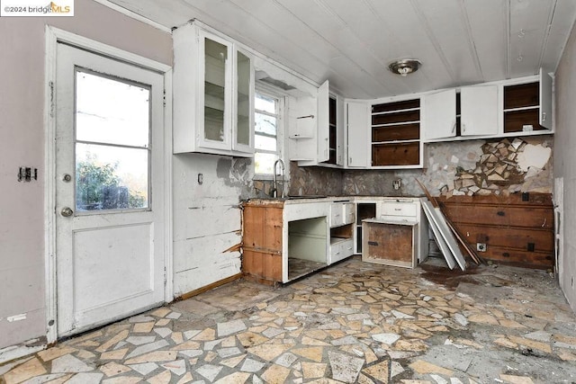 kitchen featuring white cabinets and sink