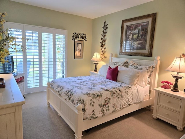 carpeted bedroom featuring multiple windows