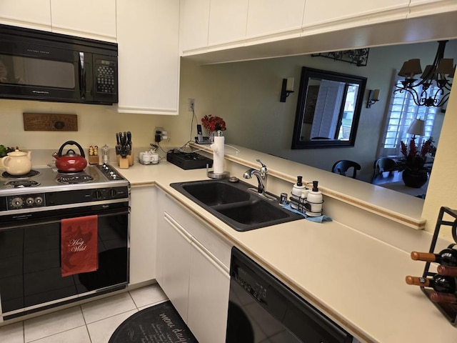 kitchen featuring sink, white cabinets, and black appliances