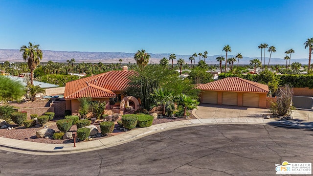 view of front of home with a mountain view and a garage