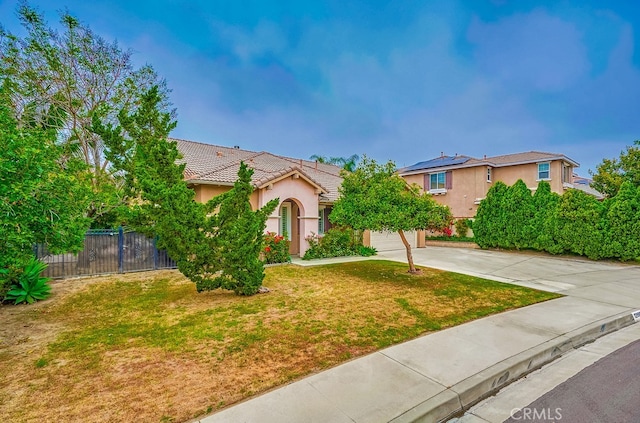 view of front of home with a front lawn and a garage