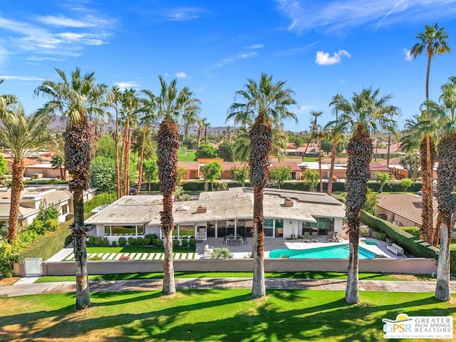 view of pool featuring a lawn and a patio