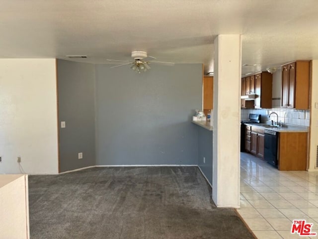 kitchen featuring dishwasher, ventilation hood, ceiling fan, tasteful backsplash, and light colored carpet