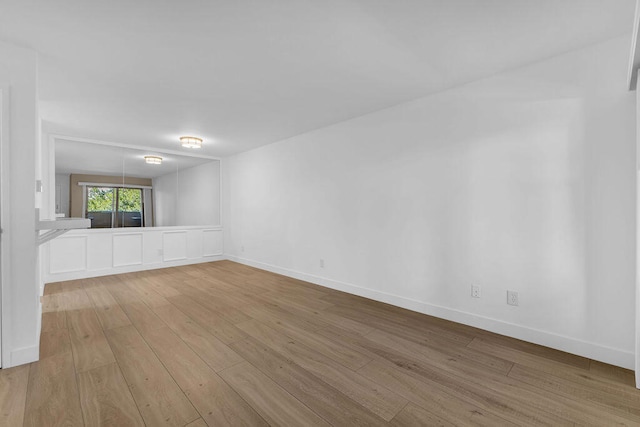 unfurnished room with light wood-type flooring