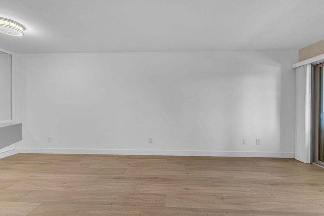 unfurnished room with light hardwood / wood-style flooring