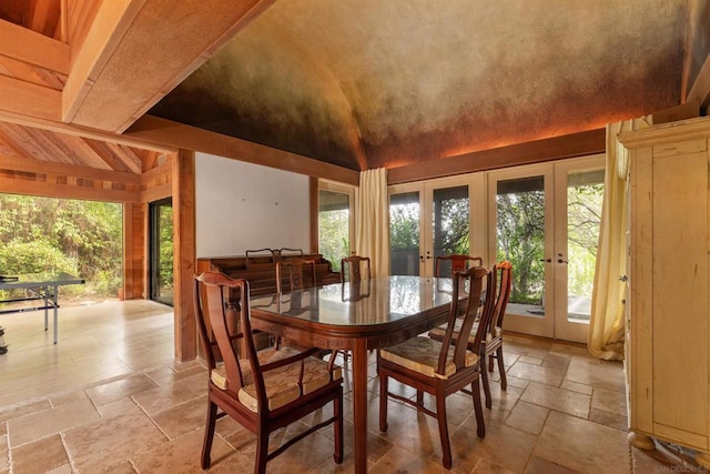 dining room with french doors and lofted ceiling