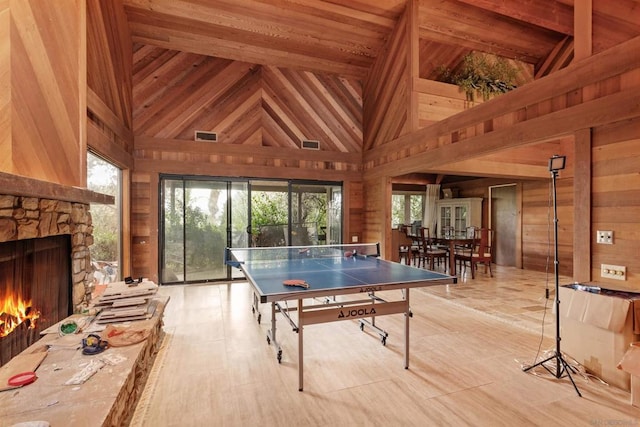 game room featuring high vaulted ceiling, wood walls, wood ceiling, and a wealth of natural light