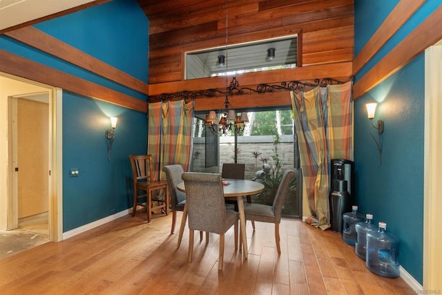 dining area with a high ceiling and hardwood / wood-style flooring