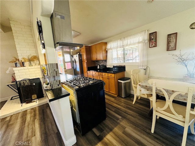 kitchen with black gas range, a wealth of natural light, and dark hardwood / wood-style flooring