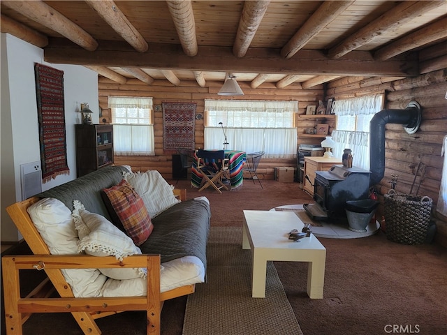 living room featuring a healthy amount of sunlight, beam ceiling, wood ceiling, and a wood stove