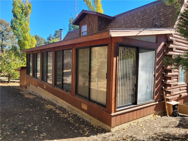 view of home's exterior with a sunroom