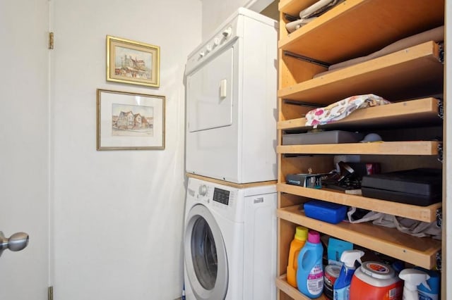 clothes washing area with stacked washer and clothes dryer