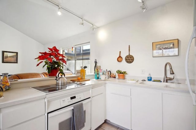 kitchen featuring white cabinetry, sink, black electric stovetop, wall oven, and kitchen peninsula