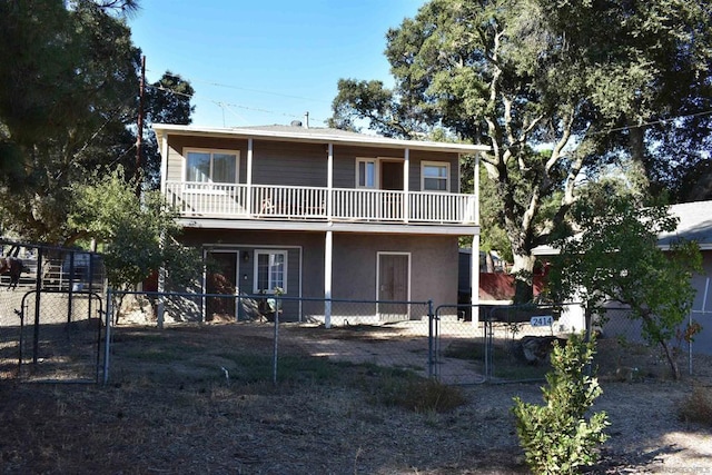 rear view of house featuring a balcony