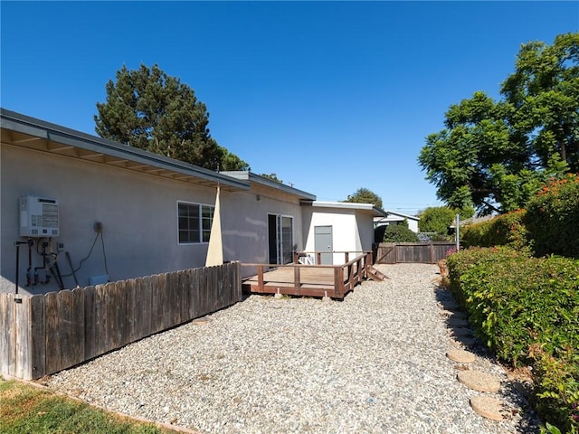 back of house featuring a deck