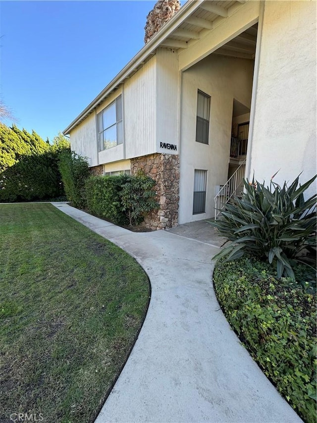 view of side of property with a lawn