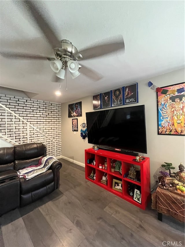 living room featuring hardwood / wood-style flooring and ceiling fan