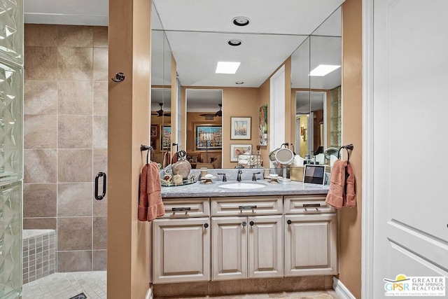 bathroom featuring vanity, an enclosed shower, and a skylight