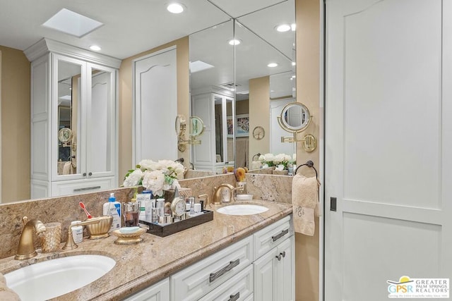 bathroom featuring vanity and a skylight